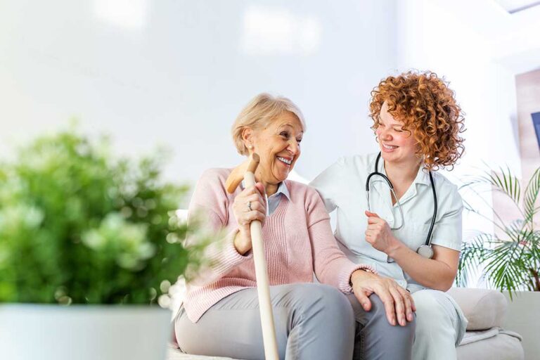 Family member reviewing a care plan with an older adult at a table in an assisted living residence.
