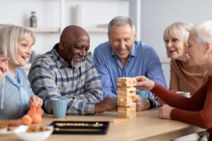 Nurse reviewing medications with an older adult in a bright assisted living room.